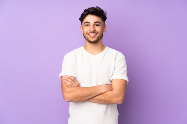 handsome-man-isolated-wall-keeping-arms-crossed-frontal-position_1368-93851